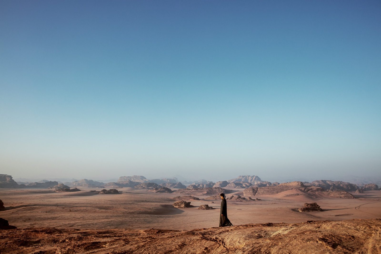 a person standing in the middle of a desert