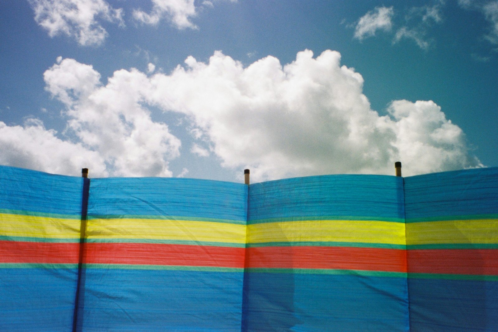 blue yellow and red striped flag under blue sky during daytime